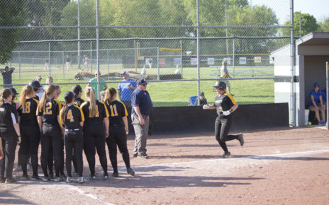 Utie Demolt is congratulated on a homerun by teamates at home plate
