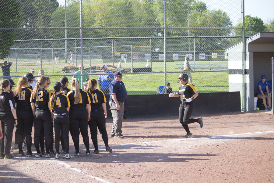 Utie Demolt is congratulated on a homerun by teamates at home plate