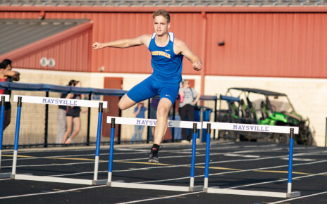Maysville Senior Colin Mathers jumping the hurdles in a Tri-Meet on their home track