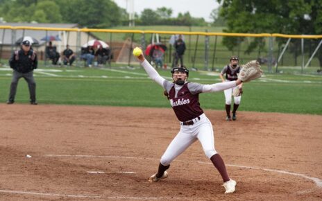 John Glenn's Kendall Snider finishing the wind-up for a pitch against Morgan
