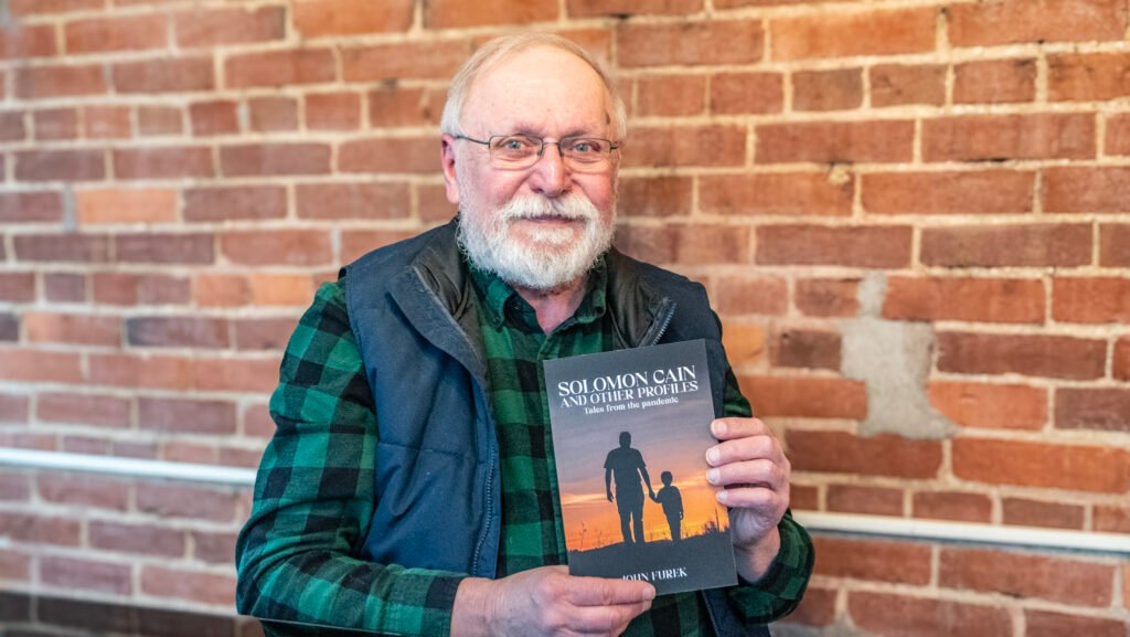 John Furek with his book