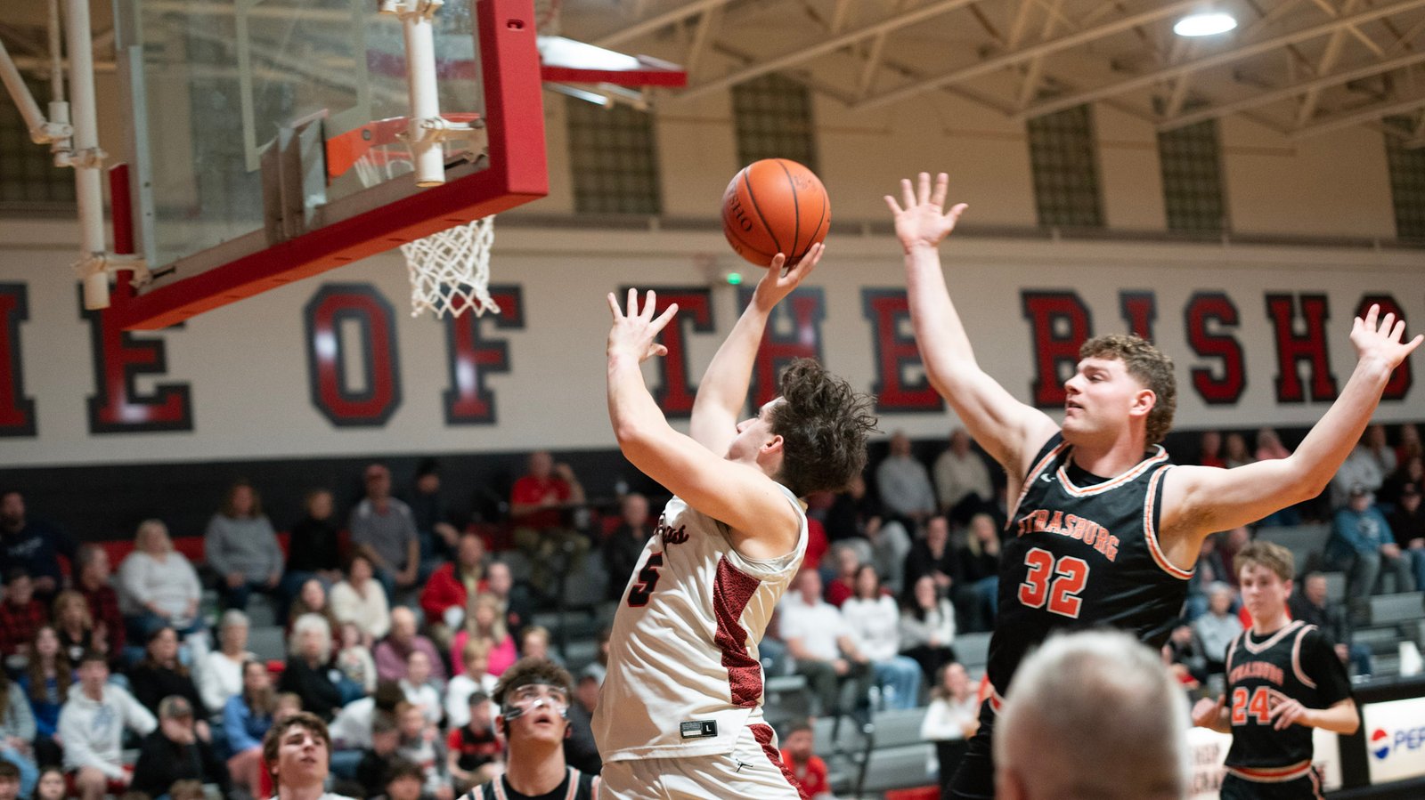 The Bishop’s Owen Lambert jumps past Strasburg for a shot