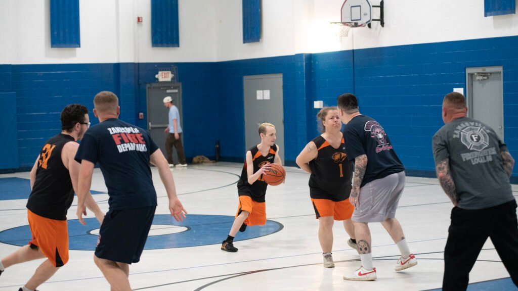 Brandon Riley maneuvered around the Fire Department Players for the Tigers