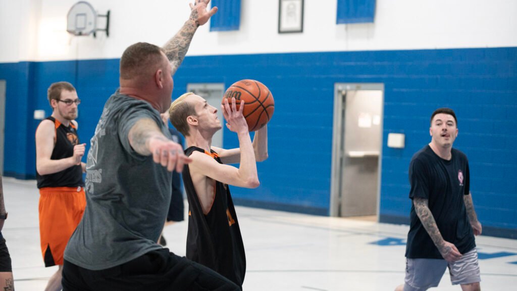 Brandon Riley aimed for a shot for the Tigers while Zanesville Fireman Jason Ankrom jumped to block