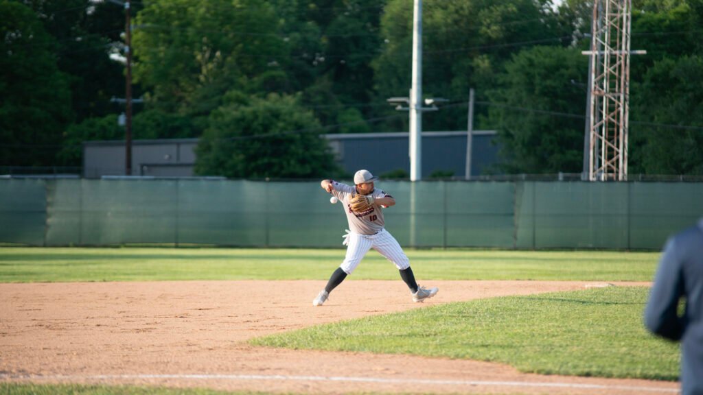 Tre Butcher mid-transition on a throw to first for the Zanesville Post 29 Senior Legion.