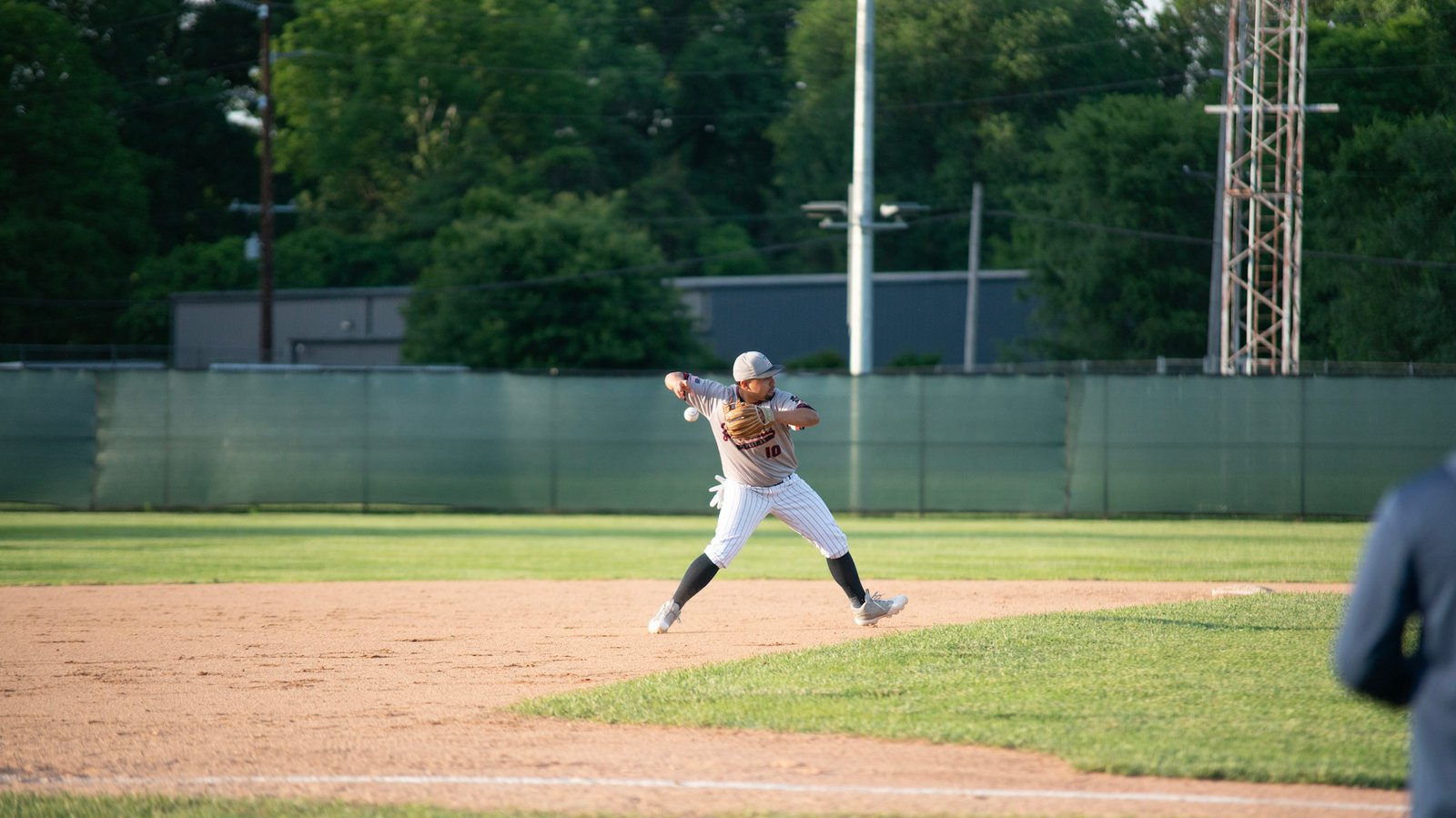 Tre Butcher mid-transition on a throw to first for the Zanesville Post 29 Senior Legion.